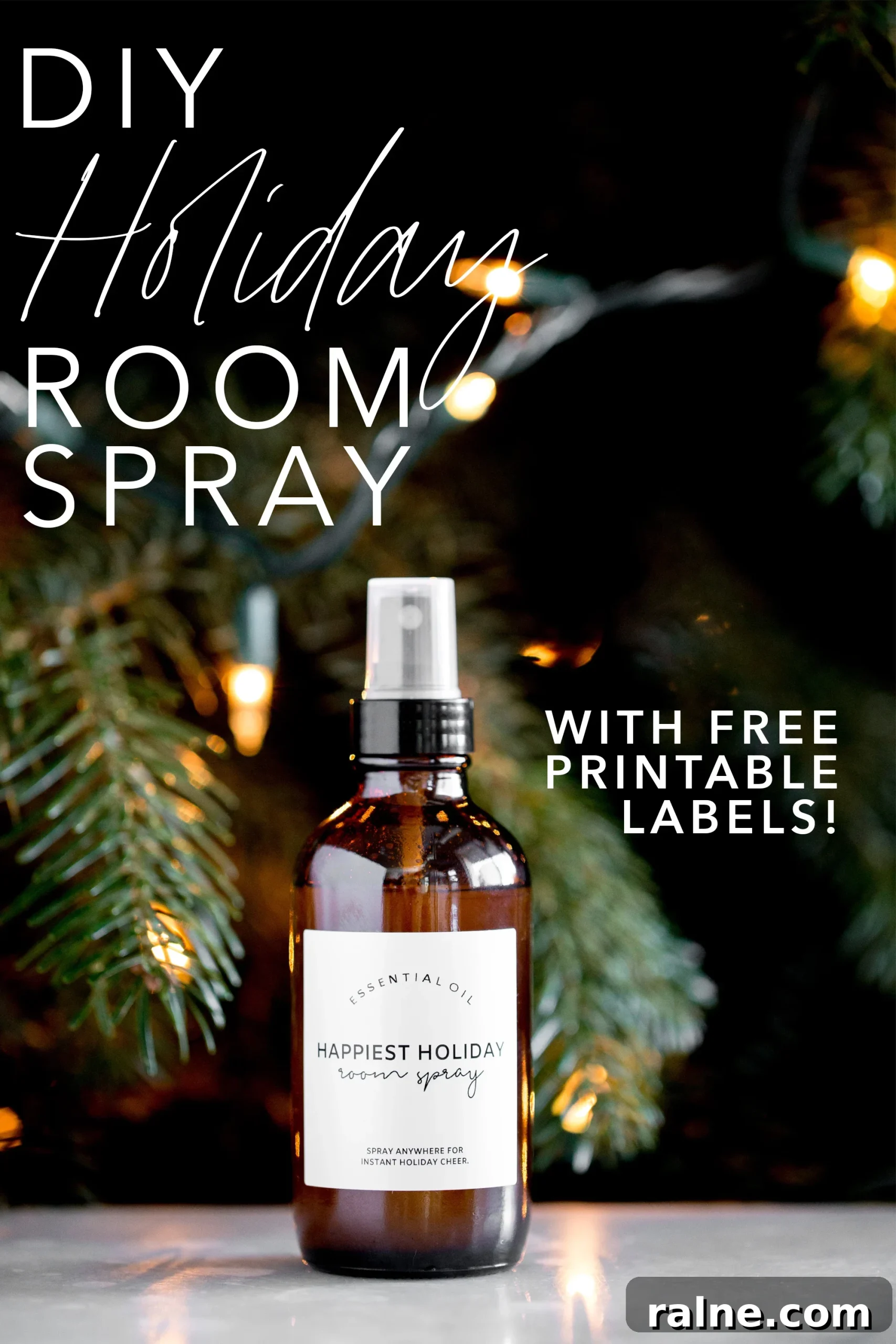 bottle of DIY essential oil holiday room spray with a lit tree in the background title text overlay