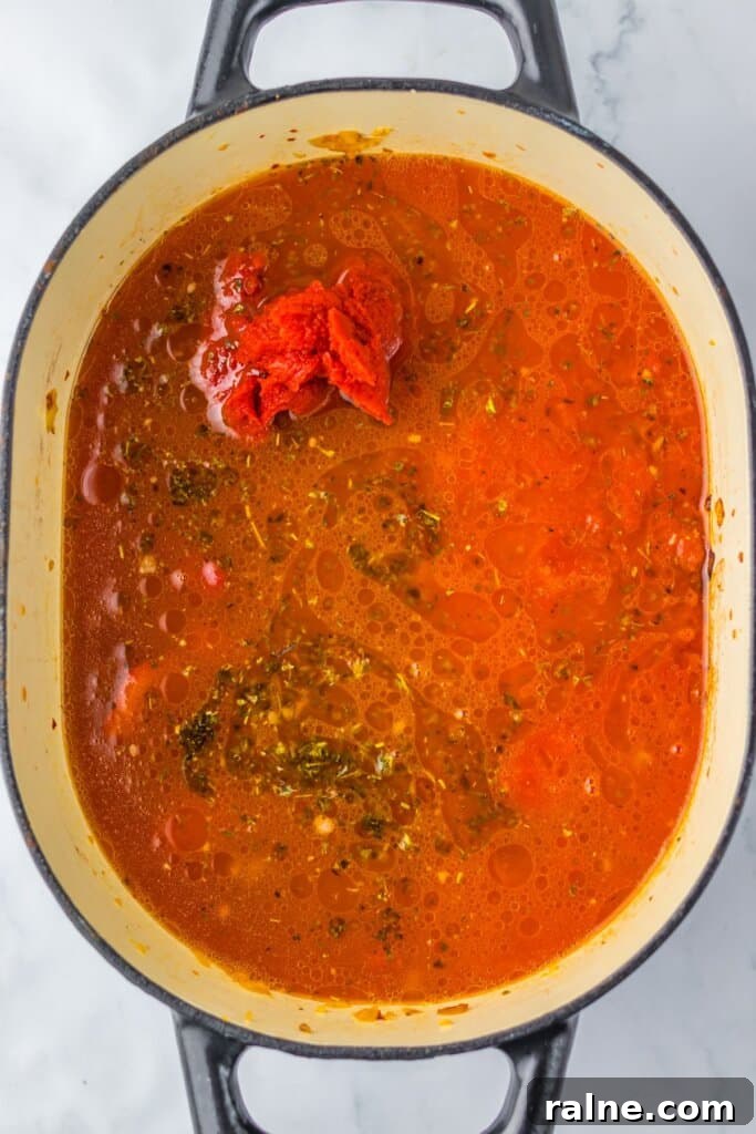 Tomatoes and seasoning in a large pot.