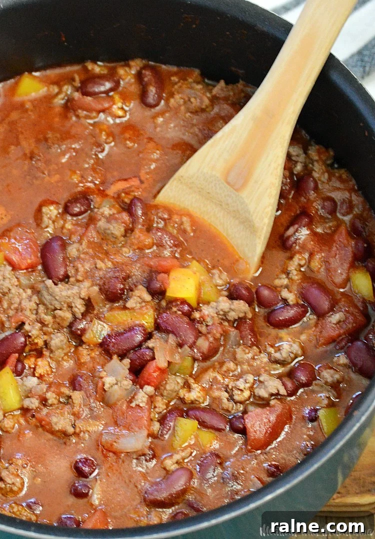 Classic Stove-Top Mom’s Chili Recipe for Weeknight Dinners 7 Stirring chili with wooden spoon
