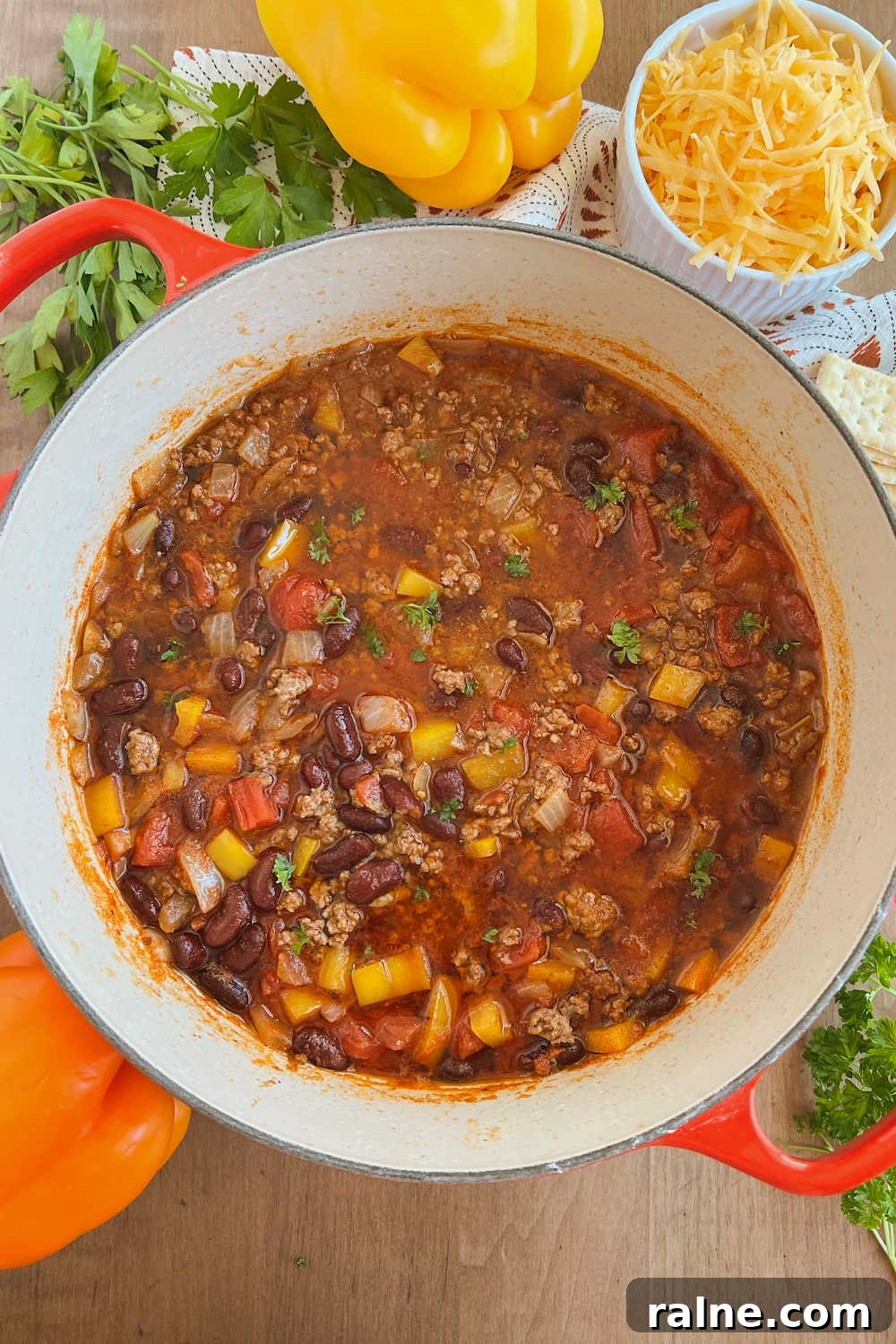 Classic Stove-Top Mom’s Chili Recipe for Weeknight Dinners 8 mild chili with ground beef in dutch oven on table
