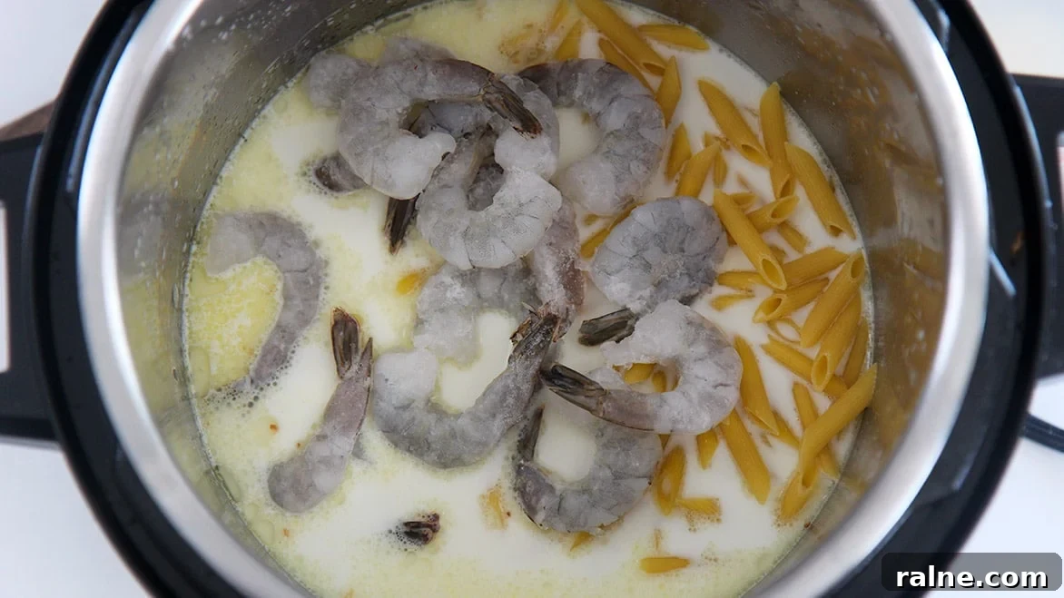 Frozen shrimp, penne pasta, and heavy cream in the instant pot.