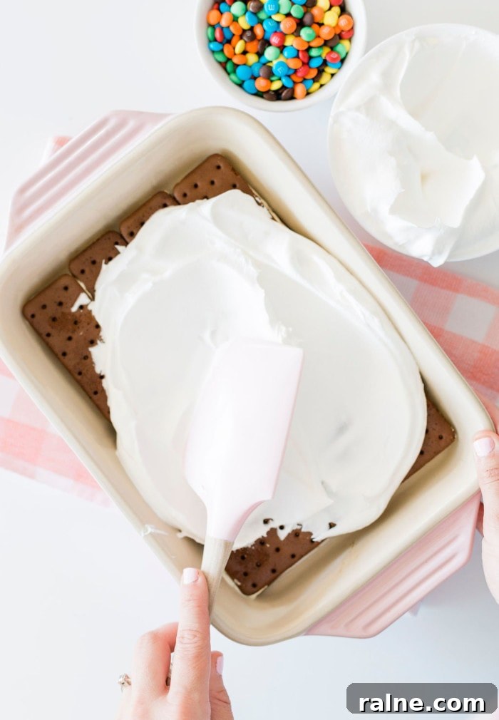 Smoothing Cool Whip on ice cream sandwiches