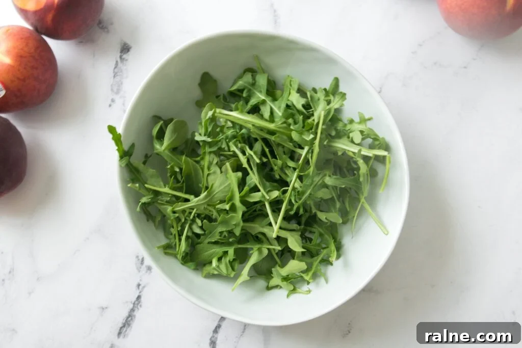 bowl of arugula with peaches