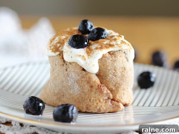 Single-Serve Blueberry Cinnamon Roll Recipe 12 Blueberry cinnamon roll on a white and gold plate.