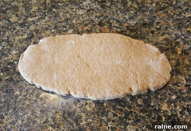 Single-Serve Blueberry Cinnamon Roll Recipe 7 Rolled out dough on a granite counter.