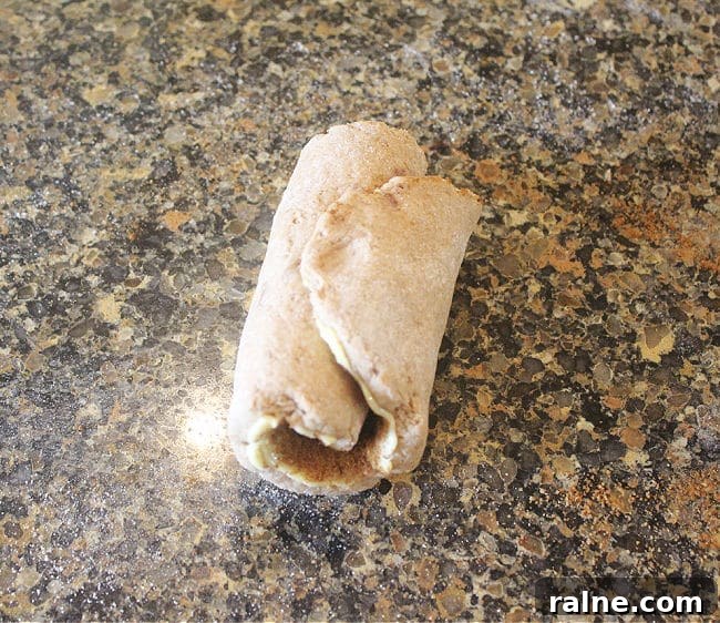Single-Serve Blueberry Cinnamon Roll Recipe 10 Rolled dough on a countertop.