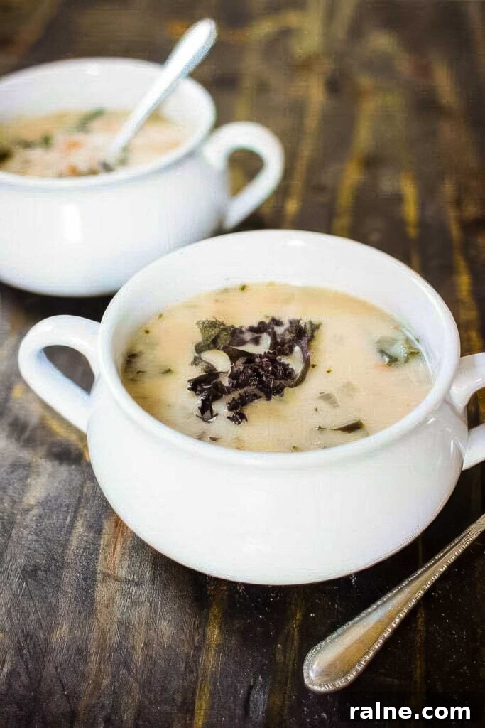 Creamy Cannellini Bean and Kale Soup Recipe for Cozy Nights 4 two white bowls of cannellini bean and kale soup on a rustic wood table