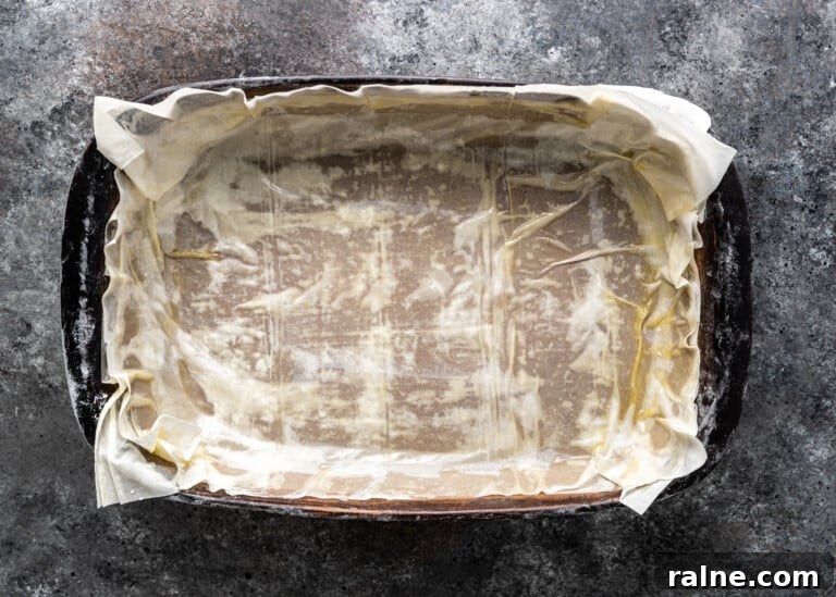 Tiropita: Authentic Greek Cheese Pie Recipe & Tips 7 overhead: bottom layer of filo in pan