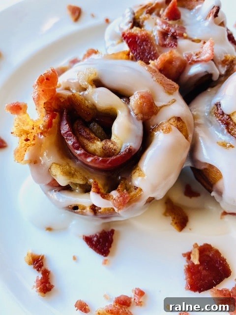 Savory Bacon and Cinnamon Rolls Recipe for Brunch Delight 5 Bacon-Cinnamon-Rolls-on-plate-with-icing-and-bacon-topping