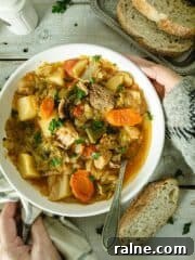 Placing a bowl of cabbage soup on a wooden table.