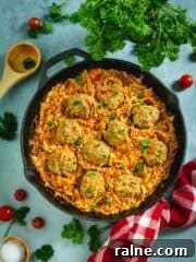 Cast-iron skillet with unstuffed cabbage rolls on a blue background.
