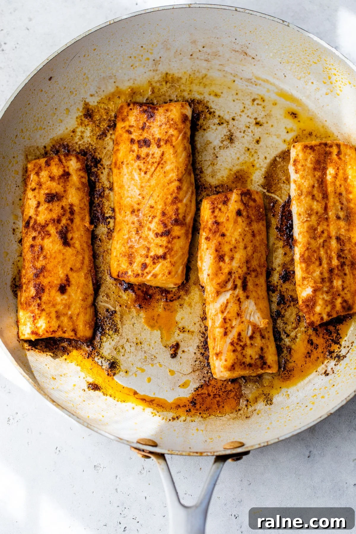 mahi mahi filets cooking in a skillet