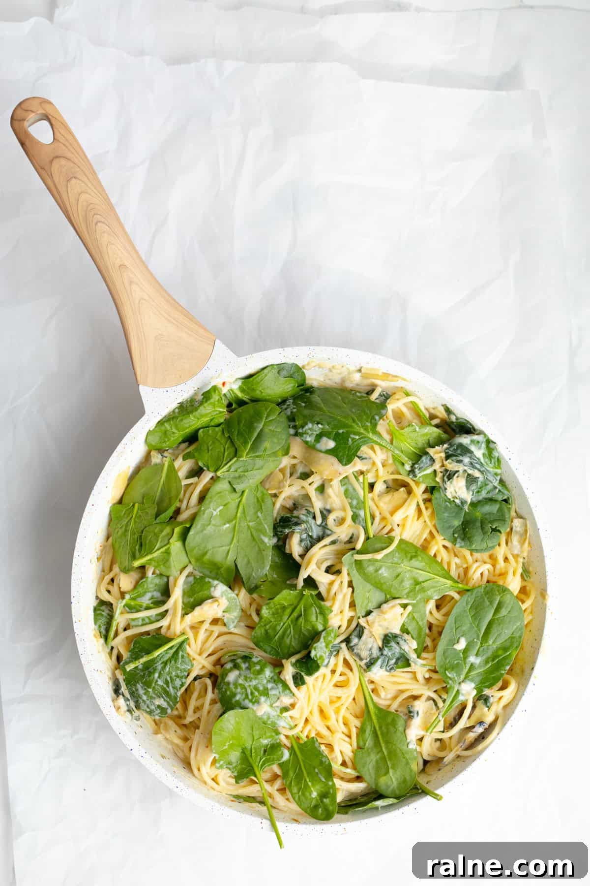 spaghetti artichoke pasta mixed together int he pan