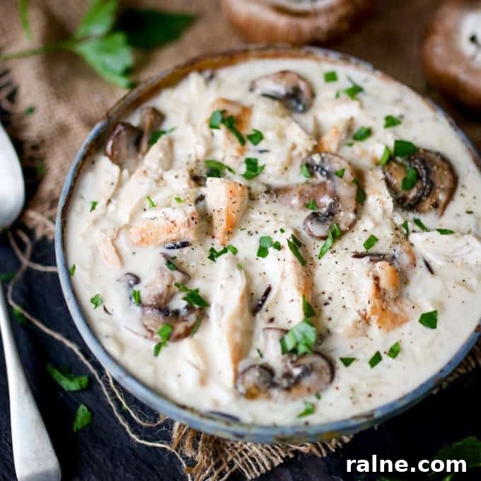 Chicken, Wild Rice & Mushroom Soup - The most comforting creamy soup ever! Savory mushrooms are the perfect veggie for this rich wild rice soup with succulent chicken.