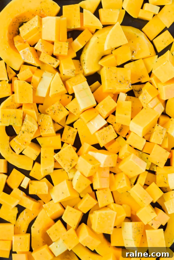 diced and cubed butternut squash on sheet pan ready to be roasted.