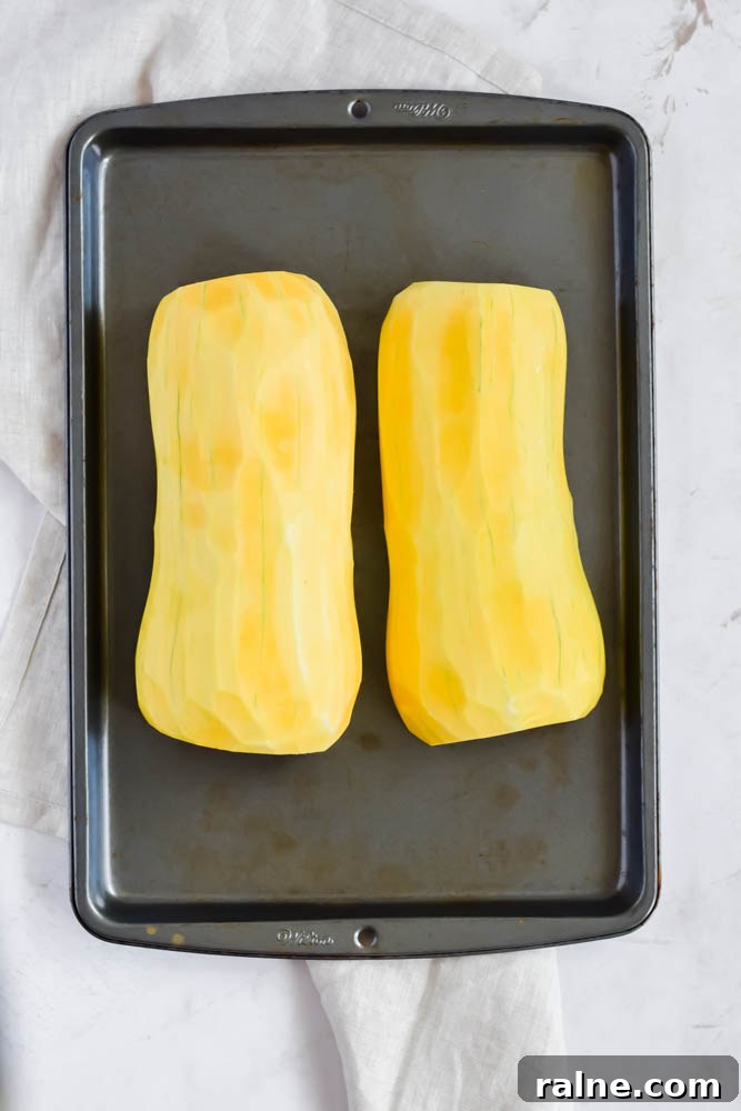butternut squash peeled and halved on sheet pan