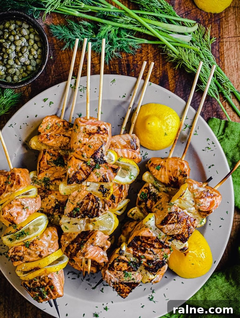 plate of salmon kabobs with lemon and dill