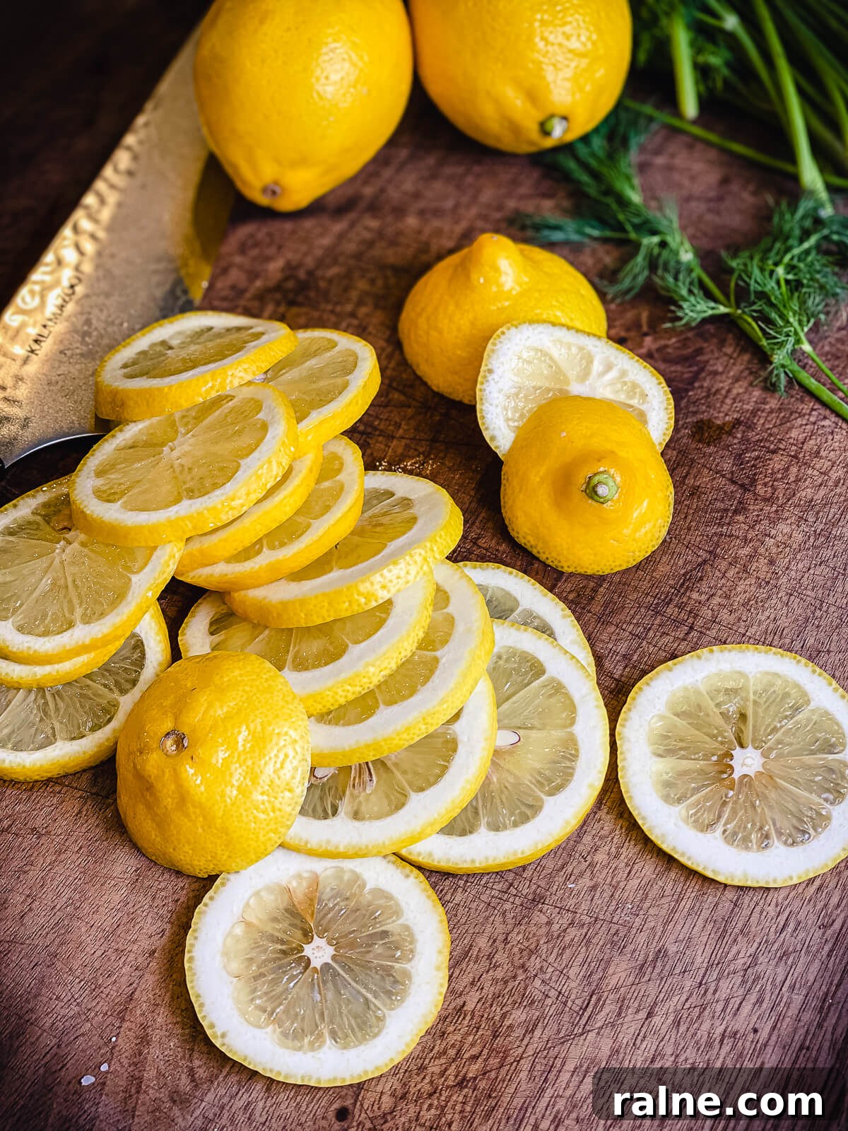 pile of sliced lemons on a cutting board
