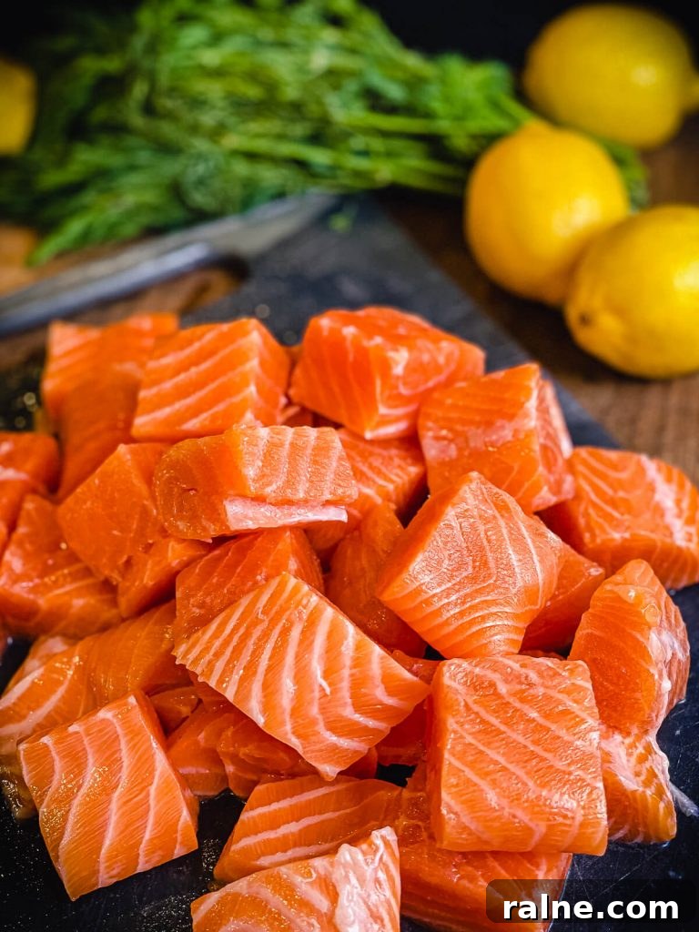 salmon cut into cubes with lemons