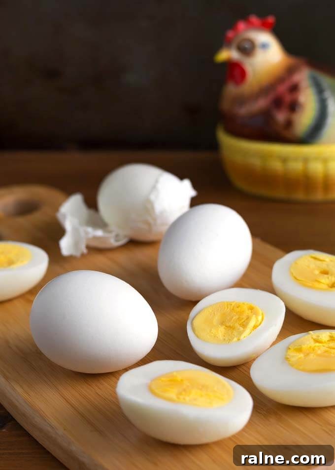 Air Fryer Boiled Eggs on wooden board in front of ceramic chicken