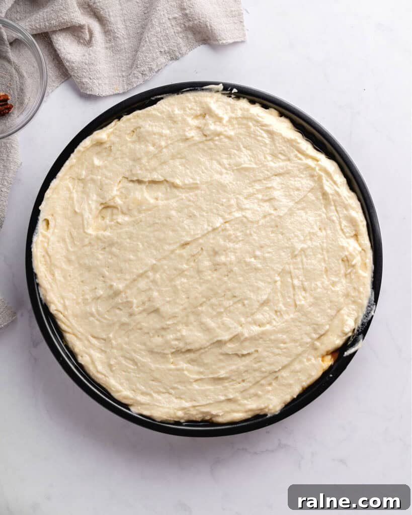 Upside down cake batter on a round cake pan. Top view. Light gray surface.