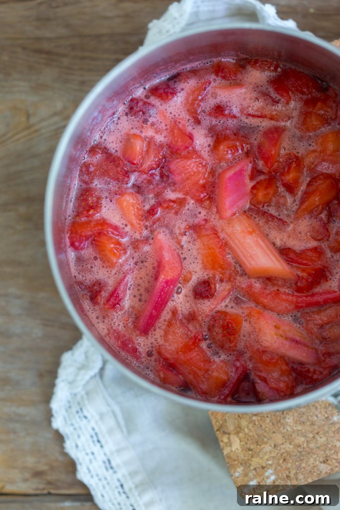 Strawberry Rhubarb Curd Tartlets Recipe for Tangy Spring Desserts 10 Simmering strawberries and rhubarb for Strawberry Rhubarb Curd