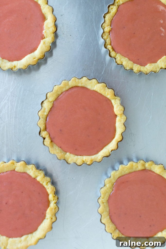 Strawberry Rhubarb Curd Tartlets Recipe for Tangy Spring Desserts 15 Filling tartlet shells with Strawberry Rhubarb Curd