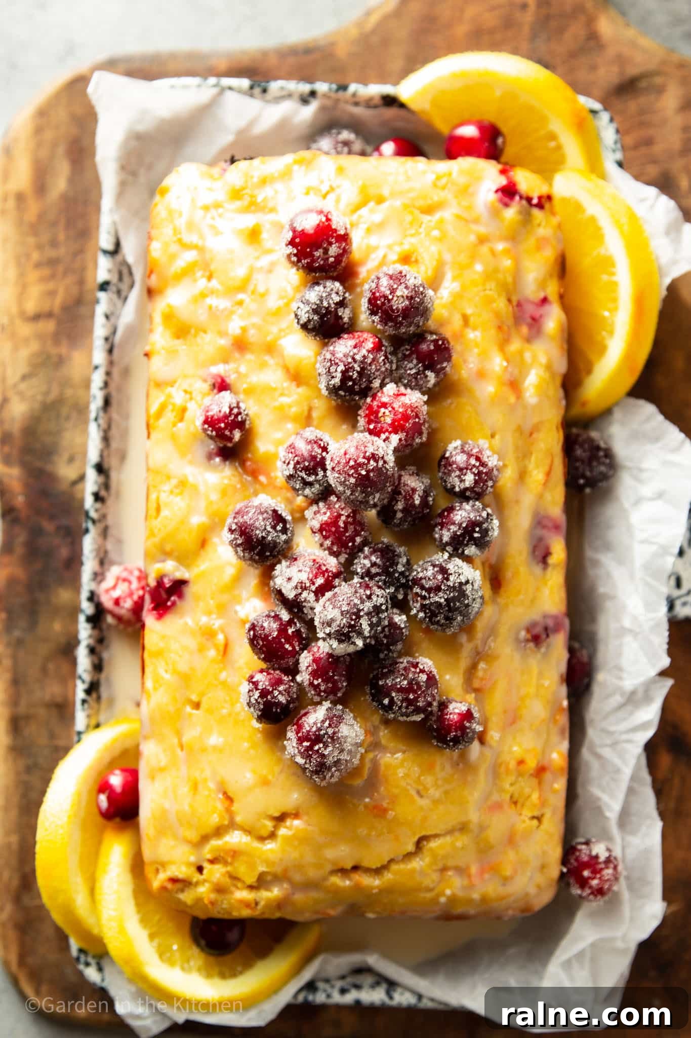 Cranberry Orange Carrot Cake Recipe with Zesty Glaze 4 overhead view of a cranberry orange carrot cake topped with sugared cranberries.
