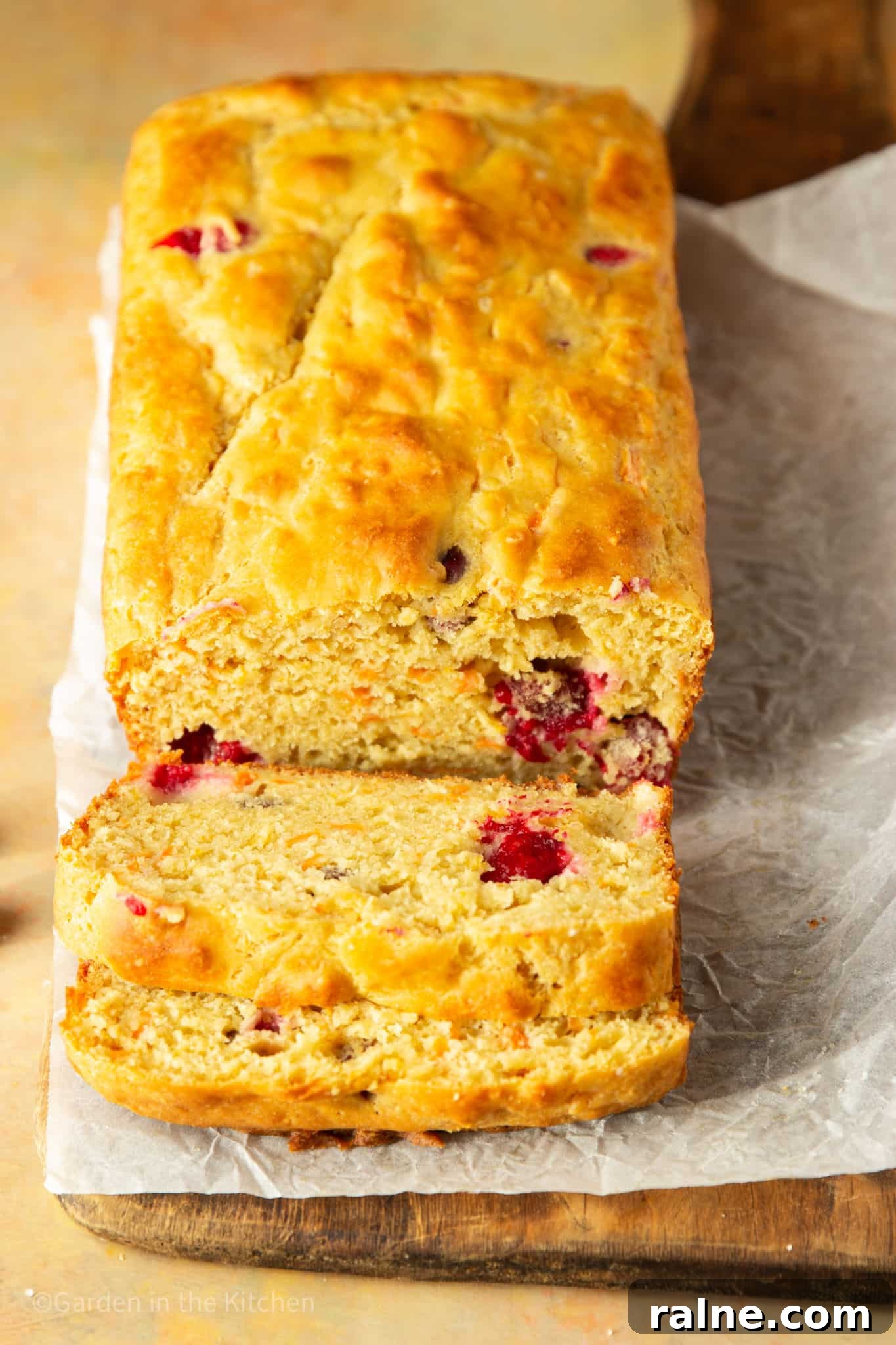 Cranberry Orange Carrot Cake Recipe with Zesty Glaze 6 cutting slices of a cranberry orange carrot cake on parchment paper.