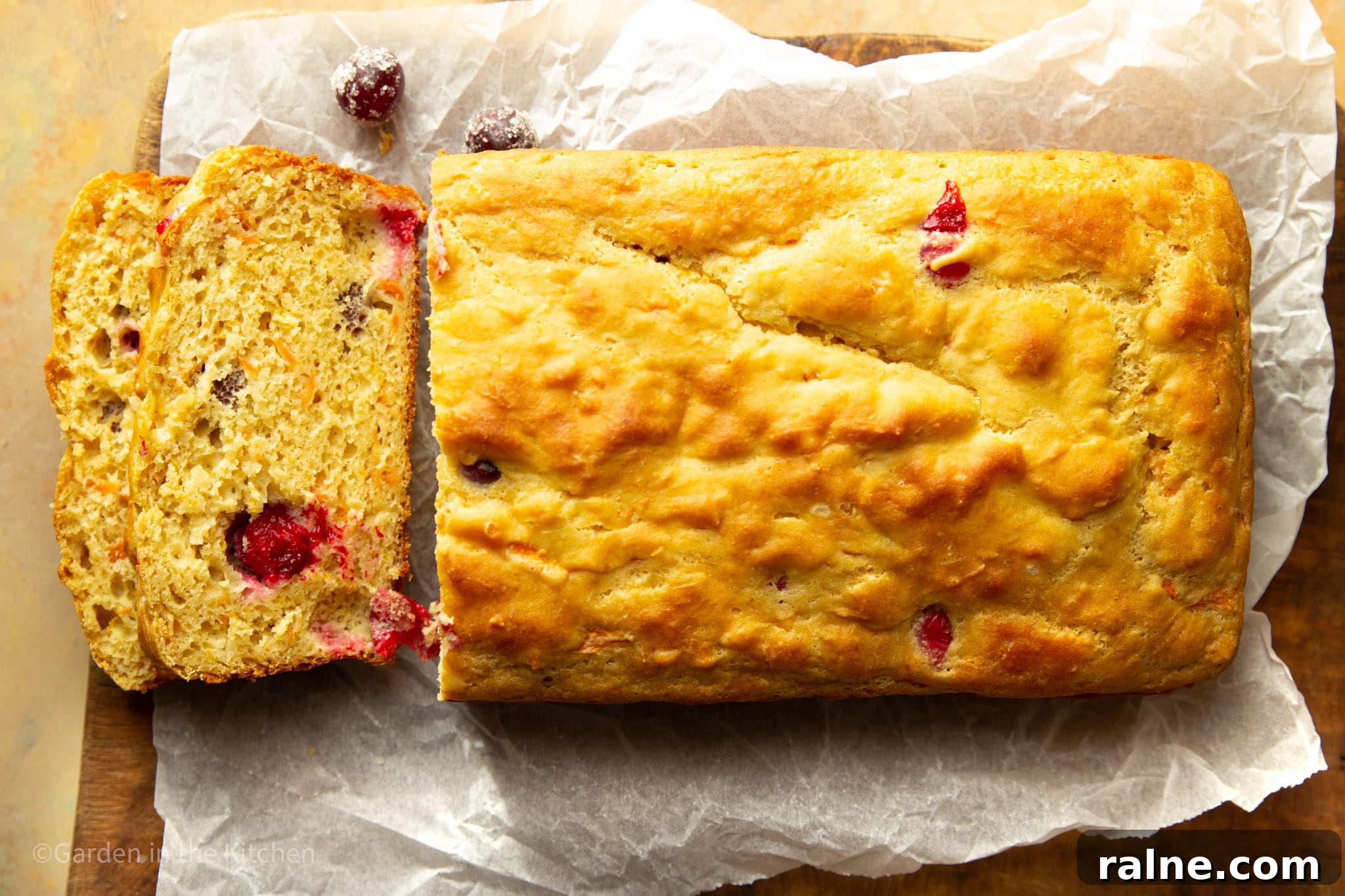 Cranberry Orange Carrot Cake Recipe with Zesty Glaze 7 cutting slices of a cranberry orange carrot cake on parchment paper.