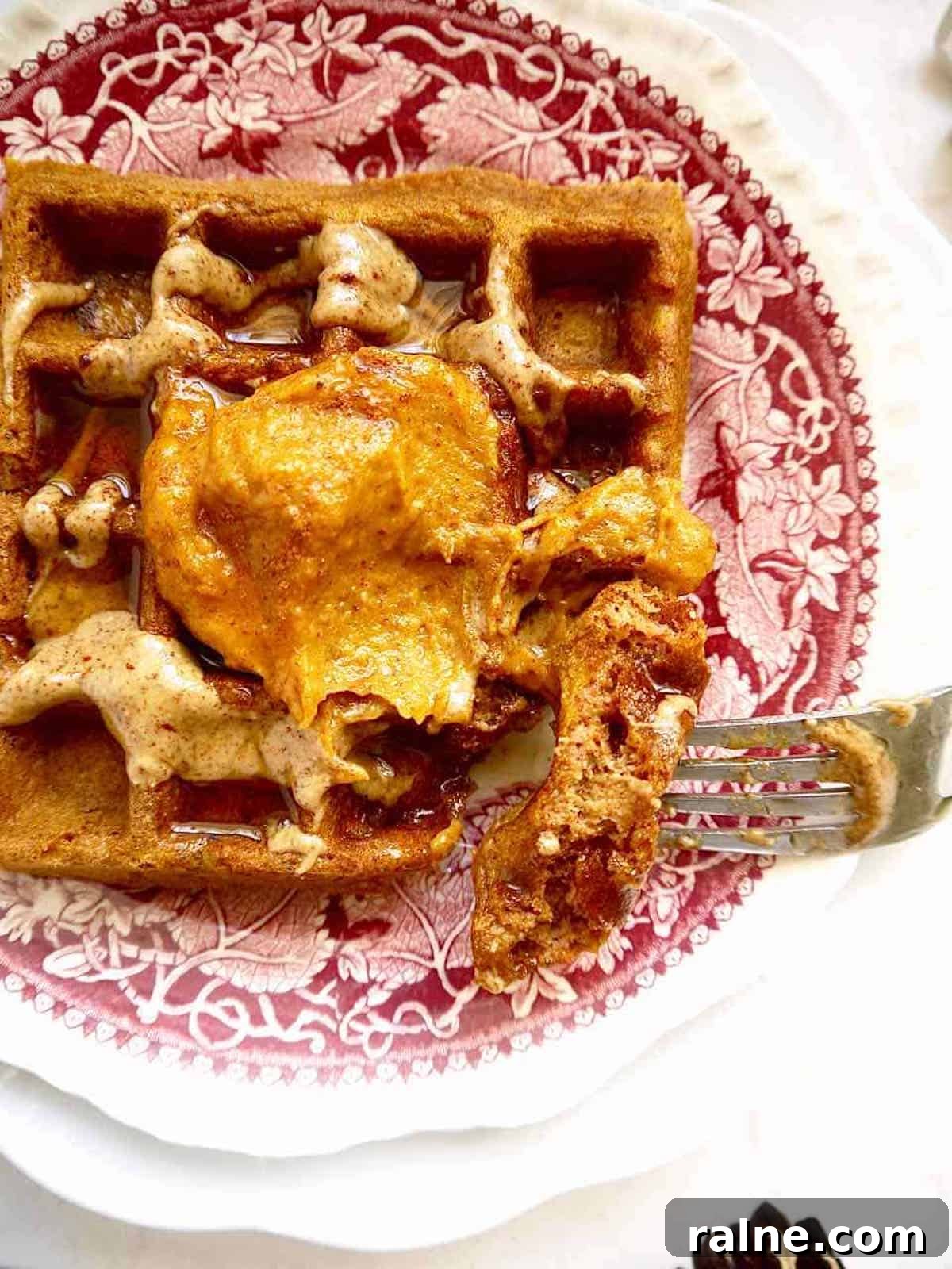 Pumpkin Paleo Waffles — Gluten- and Dairy-Free Recipe 2 Paleo pumpkin waffles covered in pumpkin frosting.