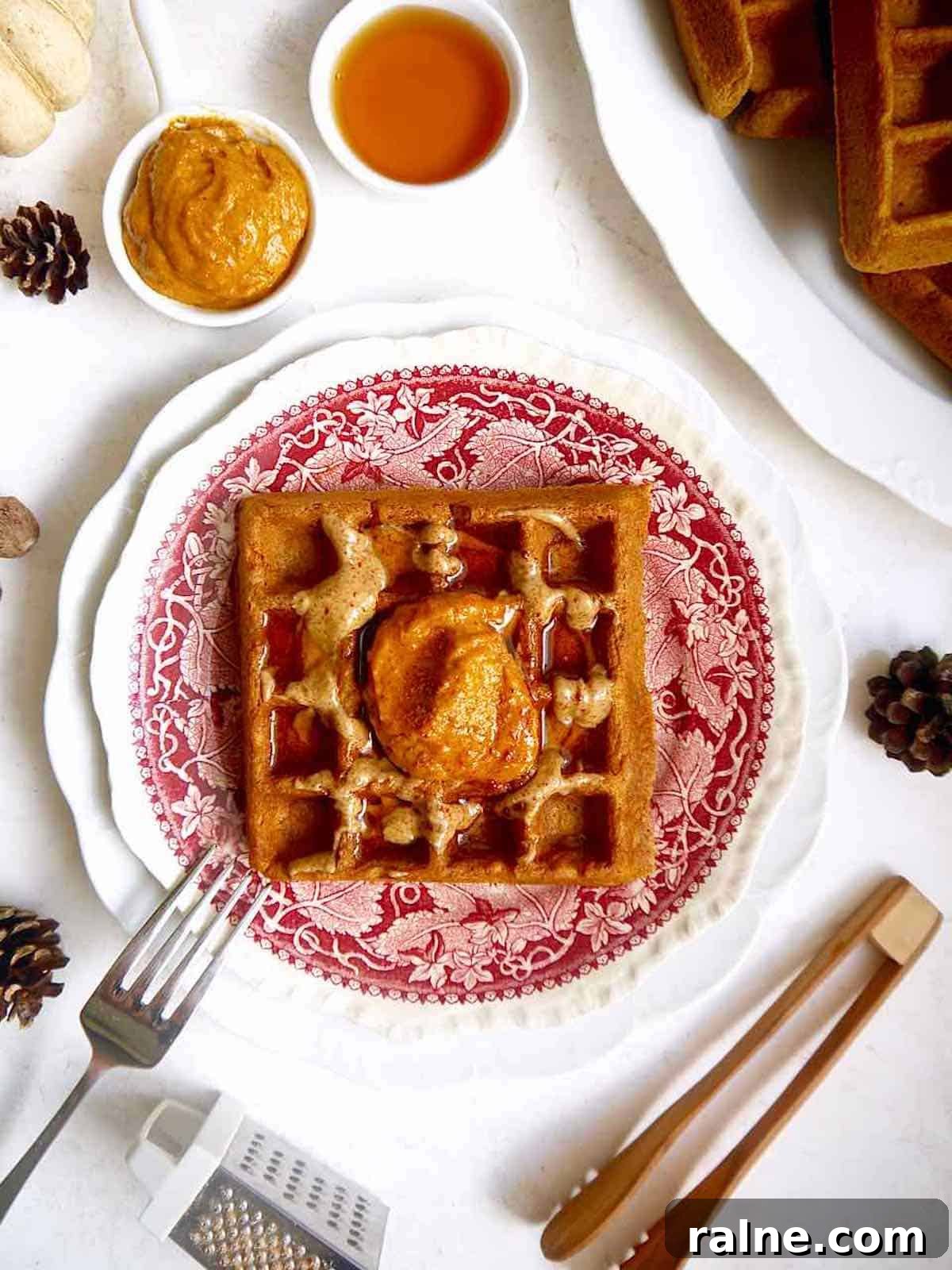 Pumpkin Paleo Waffles — Gluten- and Dairy-Free Recipe 3 Gluten-free pumpkin waffles on a plate.