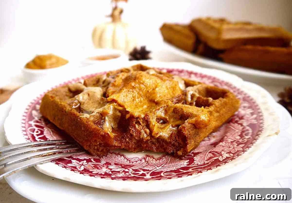 Pumpkin Paleo Waffles — Gluten- and Dairy-Free Recipe 7 Paleo pumpkin waffles with a bite taken out of them.