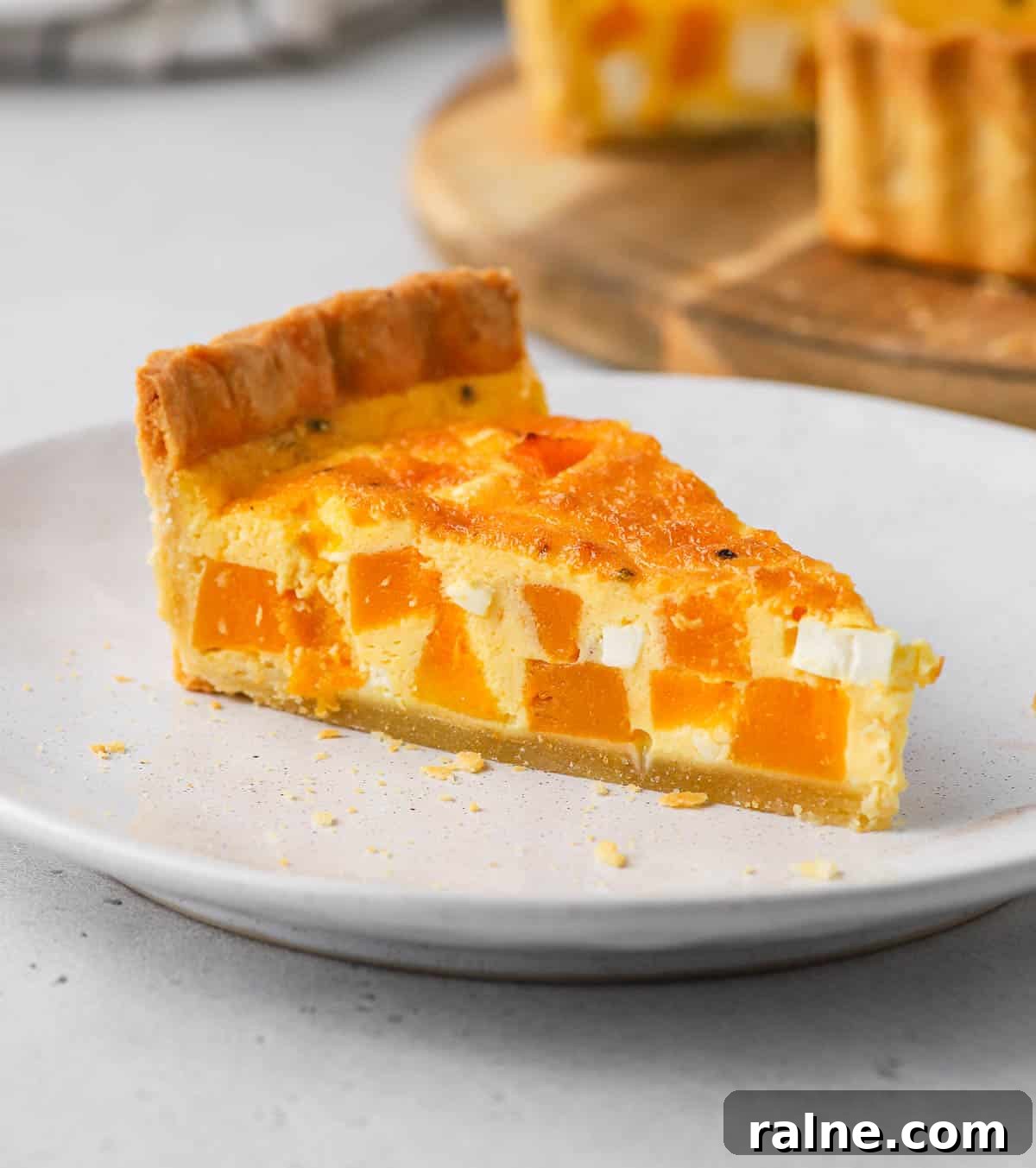 Roasted Pumpkin and Sage Quiche with Flaky Pie Crust 7 One slice of quiche on a white plate.