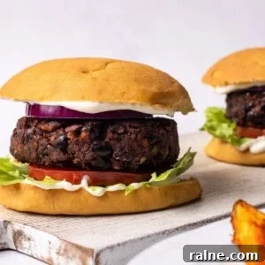 Juicy Mushroom Burger Recipe with Savory Grill-Style Flavor 15 mushroom burgers in a bun with potato wedges on the side.