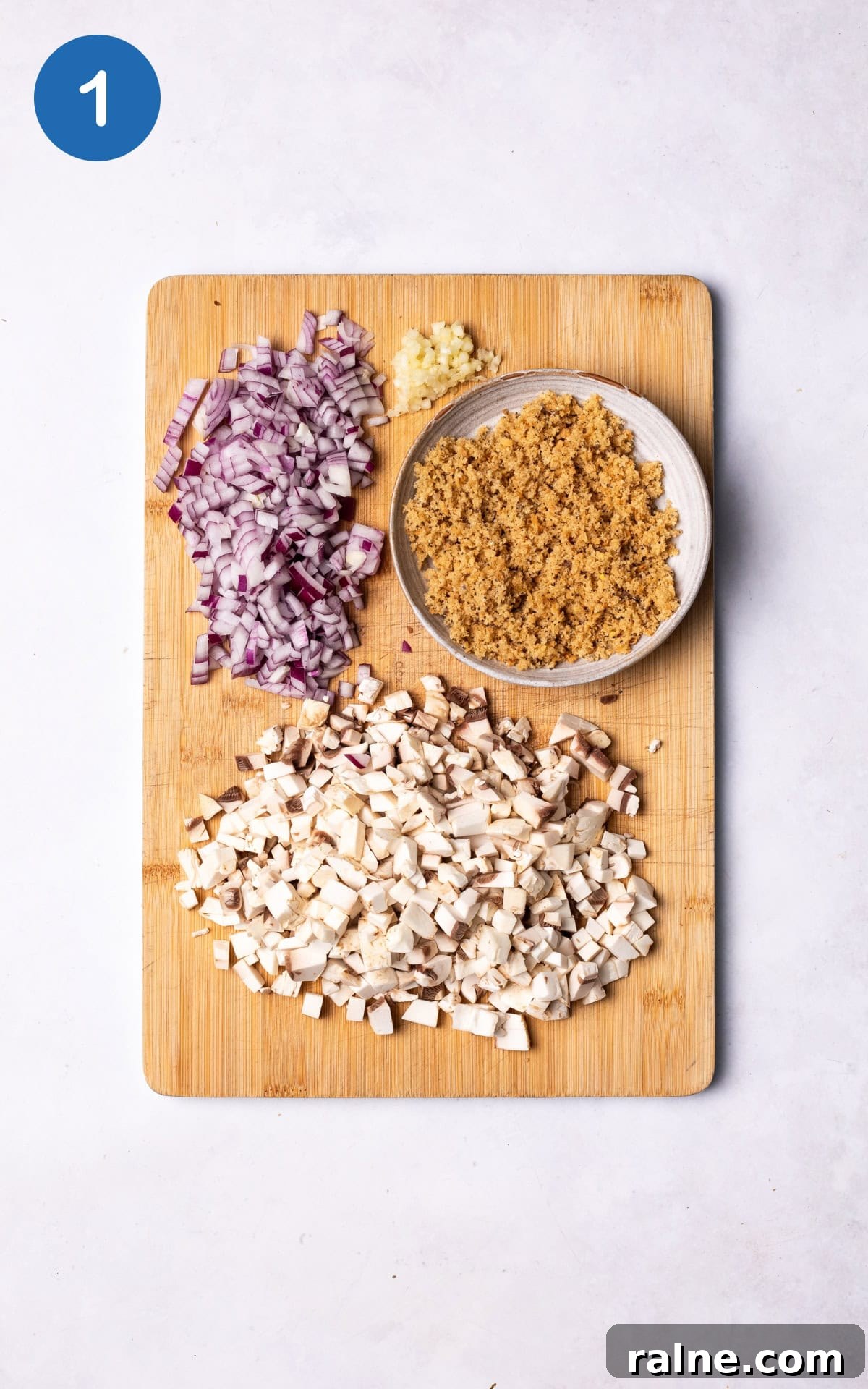 Juicy Mushroom Burger Recipe with Savory Grill-Style Flavor 4 red onion, mushrooms, garlic and bread on a wooden cutting board.