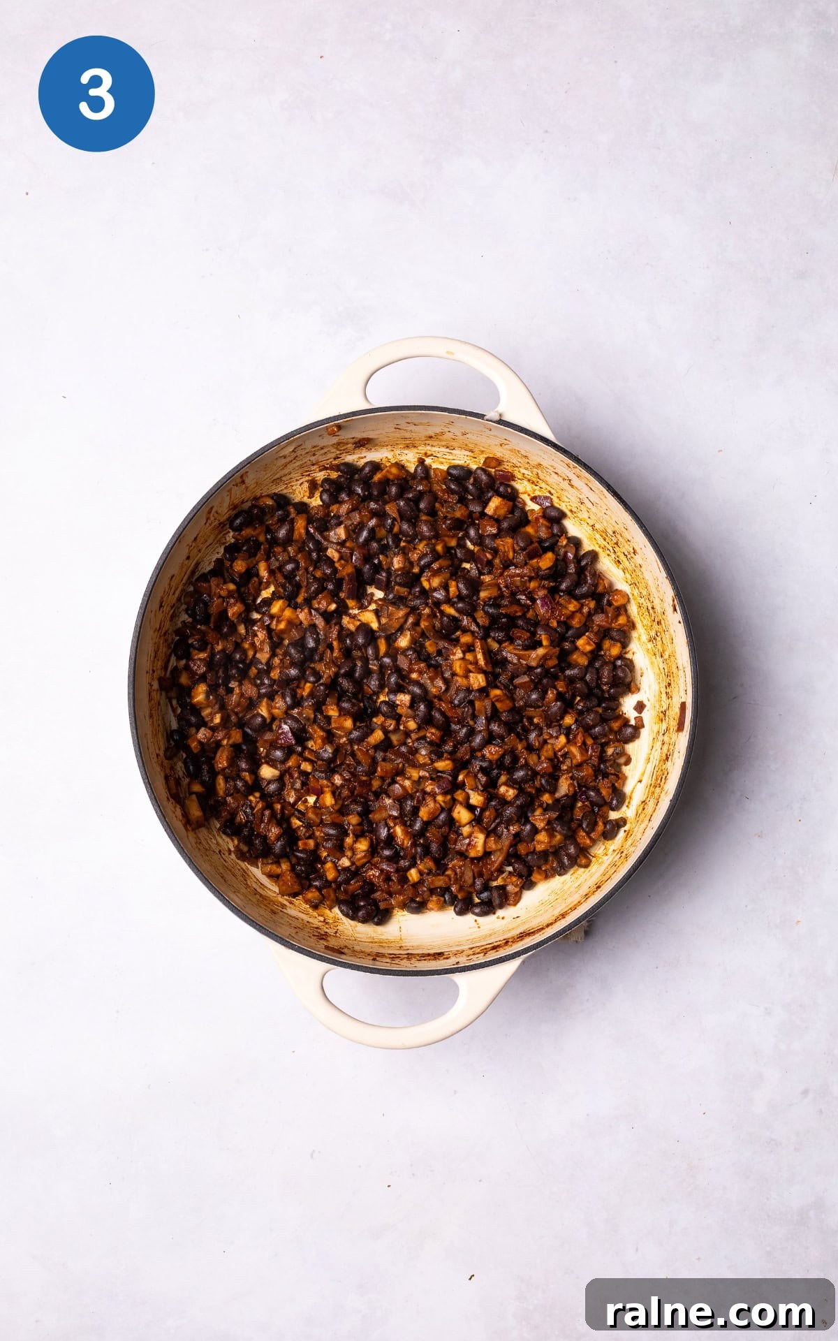 Juicy Mushroom Burger Recipe with Savory Grill-Style Flavor 6 adding black beans, smoked paprika, ground cumin, tamari, and salt to the pan.