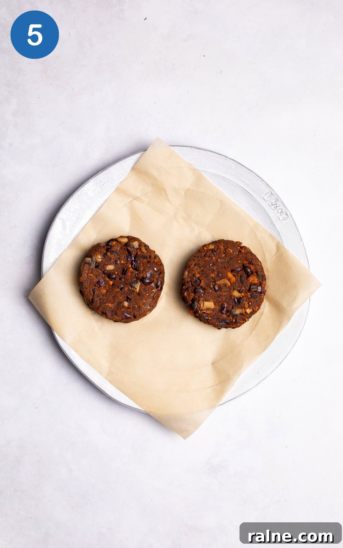 Juicy Mushroom Burger Recipe with Savory Grill-Style Flavor 8 two burger patties on a baking sheet.