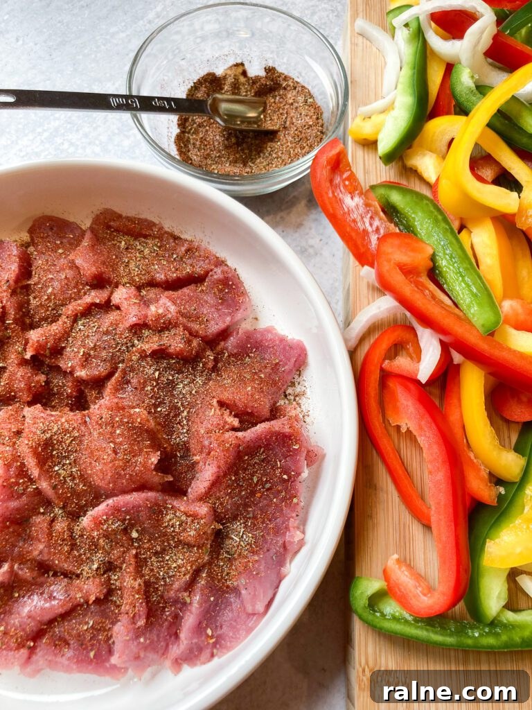 pork tenderloin sliced for fajitas with onions and peppers