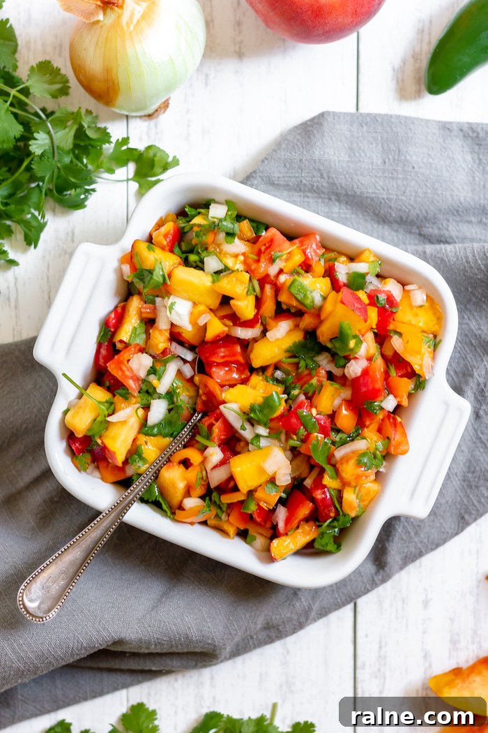 Fresh Peach Salsa Recipe for Grilling, Tacos & Summer Salads 2 Image shows a dish of colorful peach and tomato salsa
