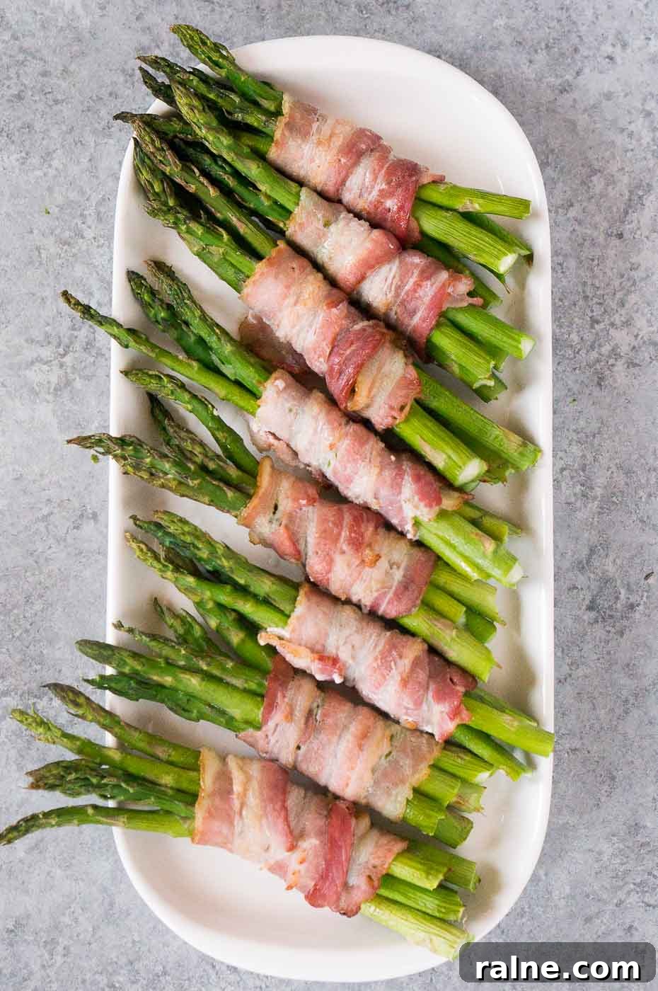 Crispy Bacon-Wrapped Asparagus Recipes for Flavorful Sides 5 asparagus wrapped in bacon on a plate