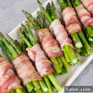 Crispy Bacon-Wrapped Asparagus Recipes for Flavorful Sides 6 bacon wrapped asparagus bundles on a platter