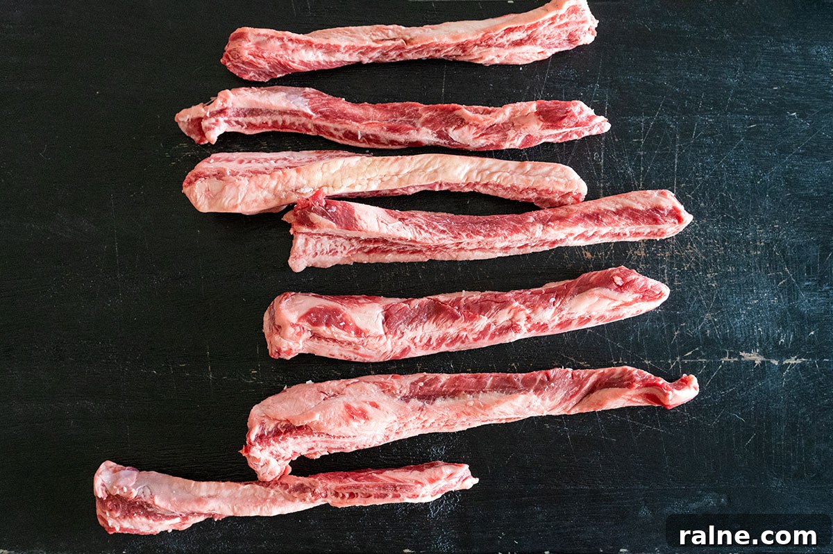 Beef Ribs Guide: Short Ribs, Back Ribs, Flanken & Cooking Tips 14 Raw beef fingers on a black board.