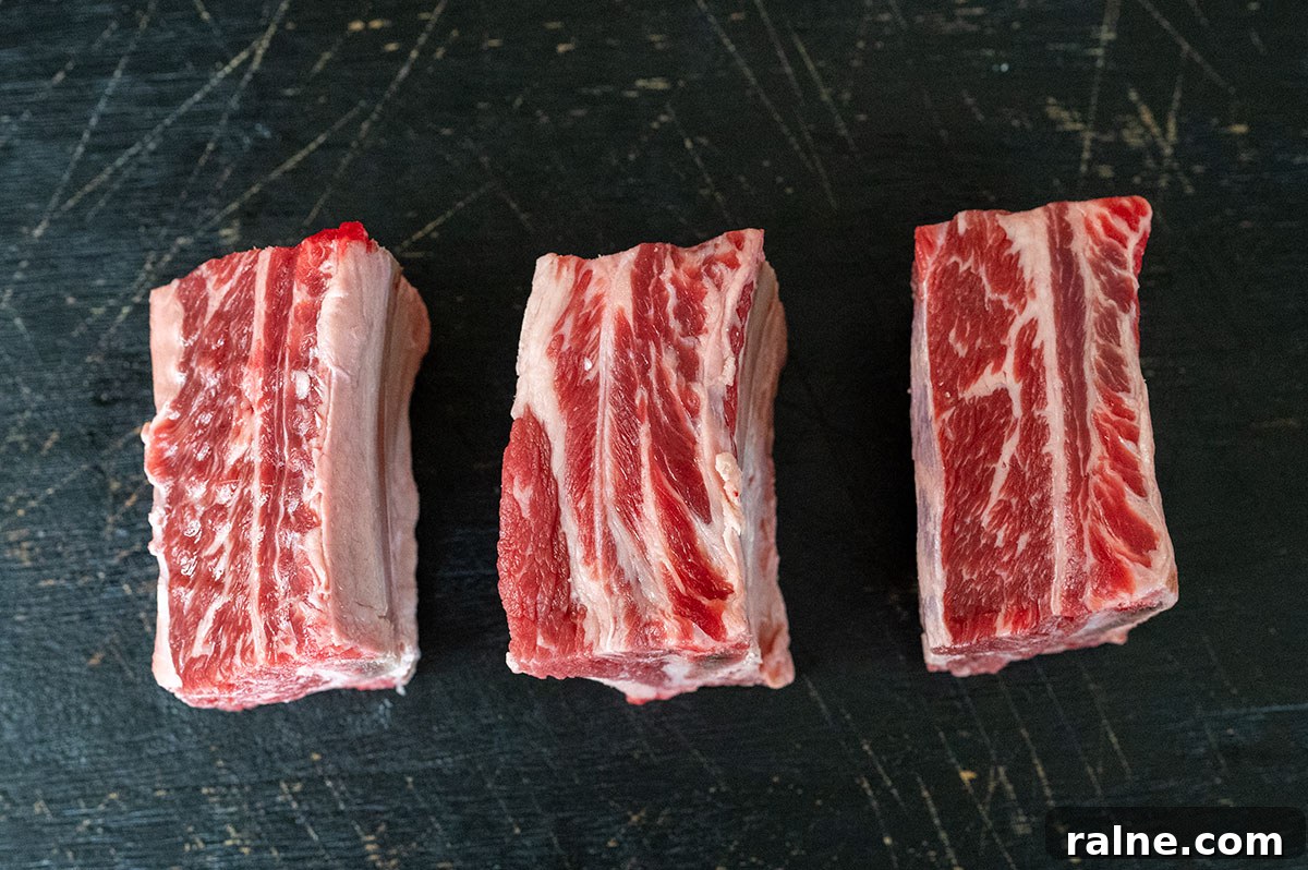 Beef Ribs Guide: Short Ribs, Back Ribs, Flanken & Cooking Tips 8 raw short ribs on black board.