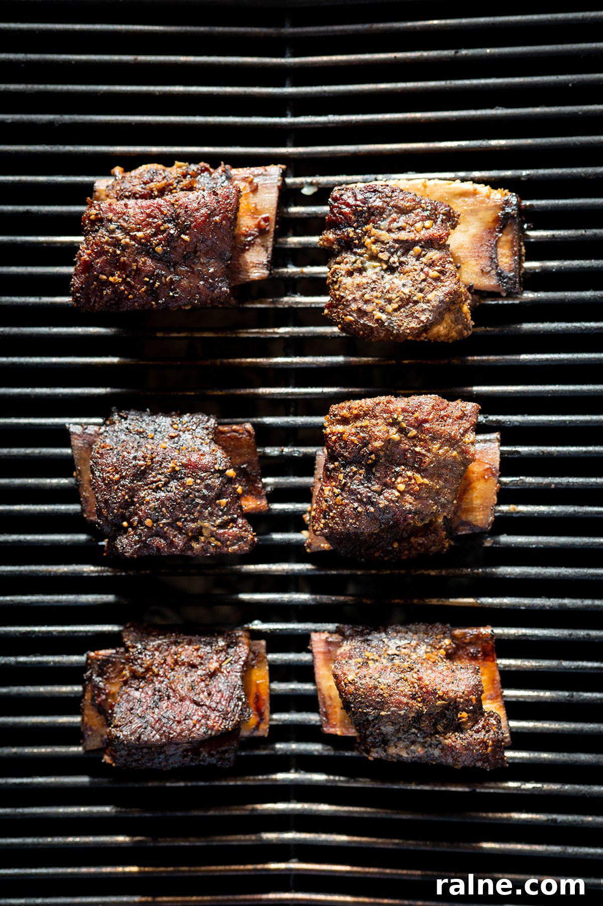 Beef Ribs Guide: Short Ribs, Back Ribs, Flanken & Cooking Tips 9 6 short ribs smoking on grill.
