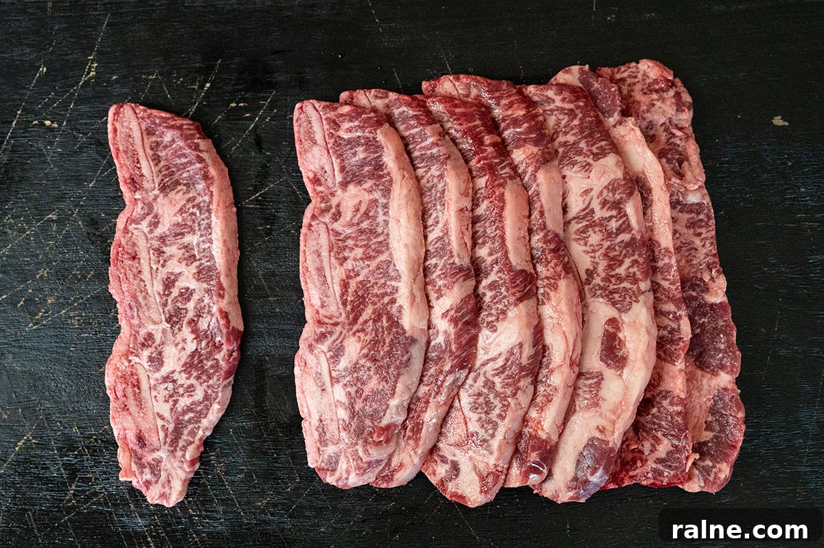 Beef Ribs Guide: Short Ribs, Back Ribs, Flanken & Cooking Tips 10 raw flanken-cut short ribs on black board.