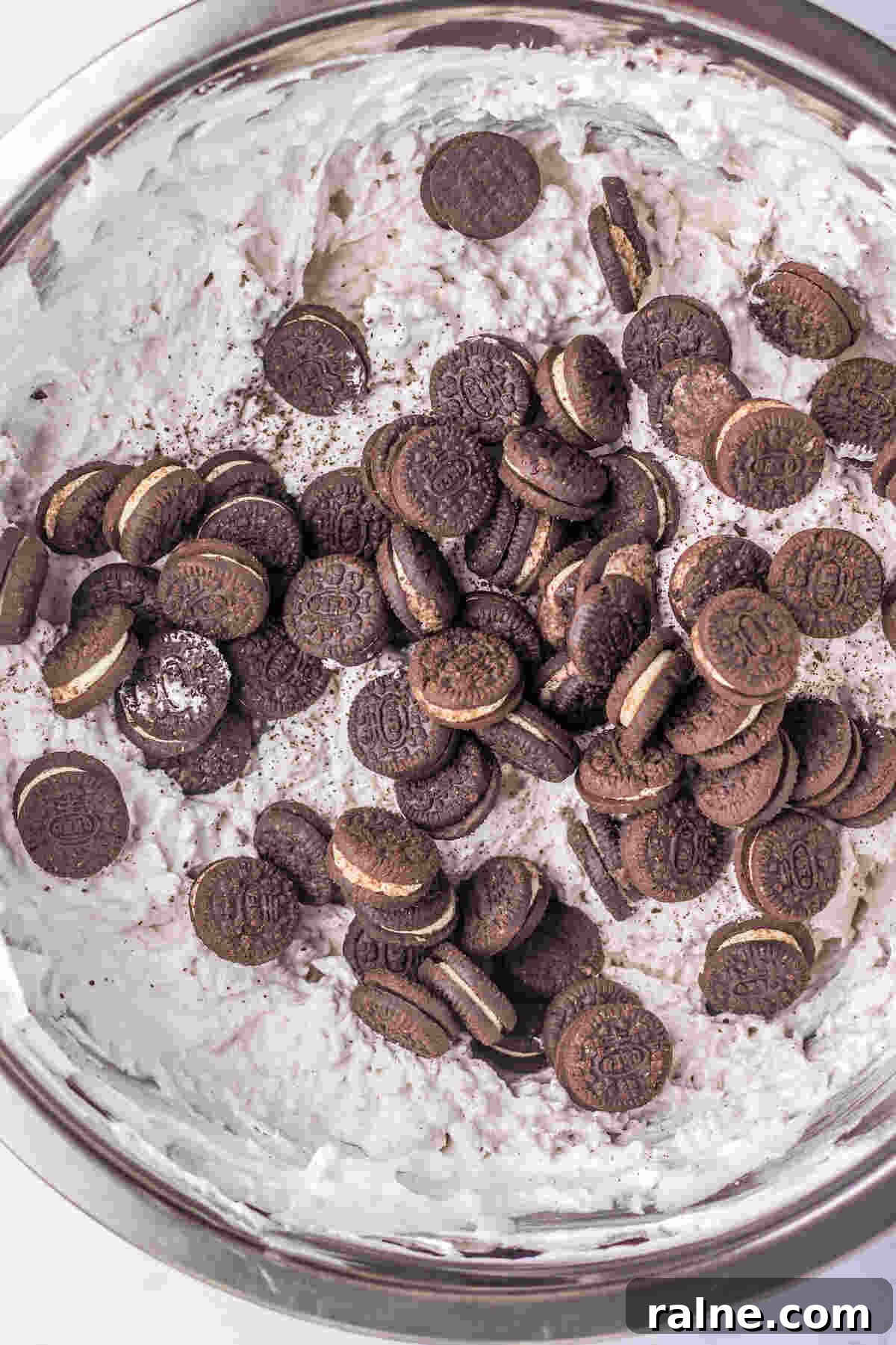 Creamy Oreo Fluff Dessert Recipe: No-Bake Oreo Delight 5 the mini oreos being added to the fluff mixture.