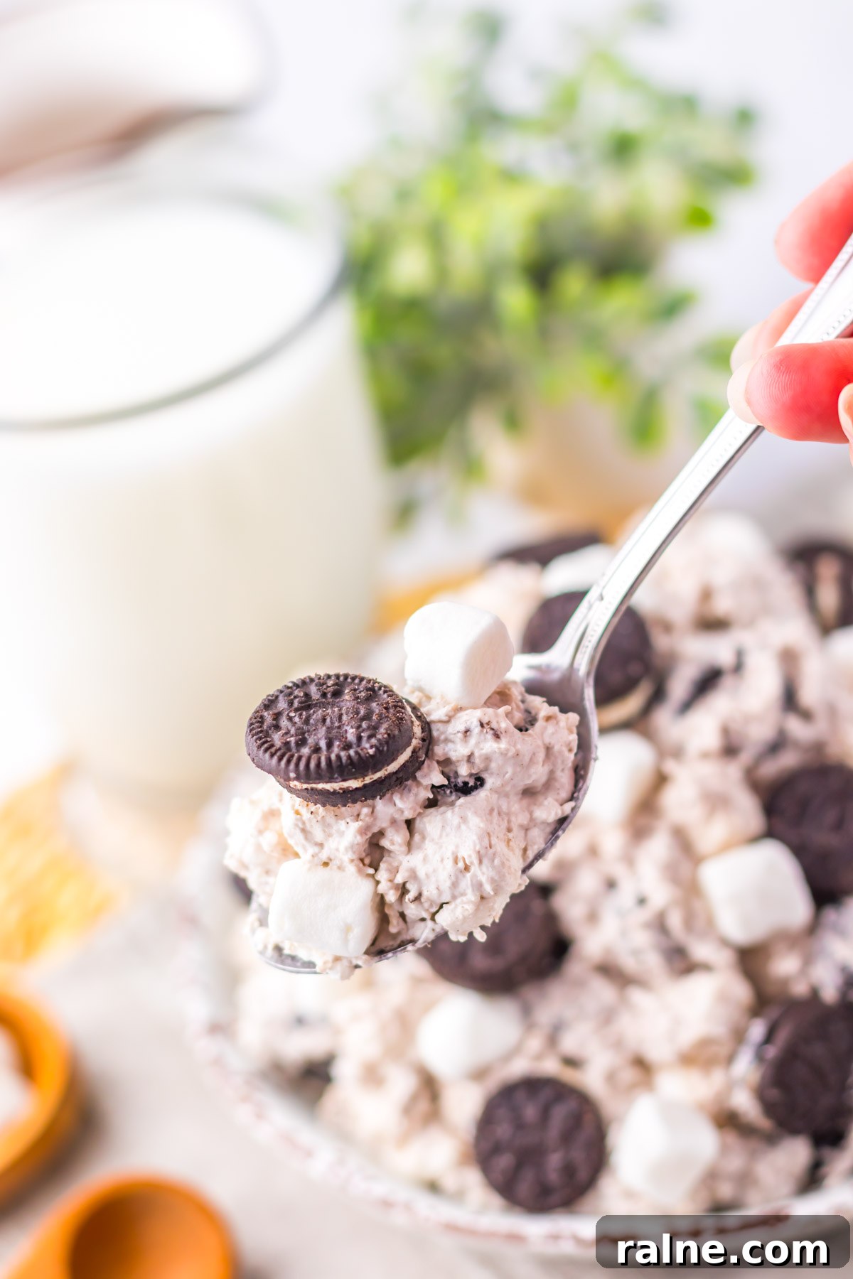 Creamy Oreo Fluff Dessert Recipe: No-Bake Oreo Delight 8 a spoon removing one portion of the oreo fluff from a bowl.