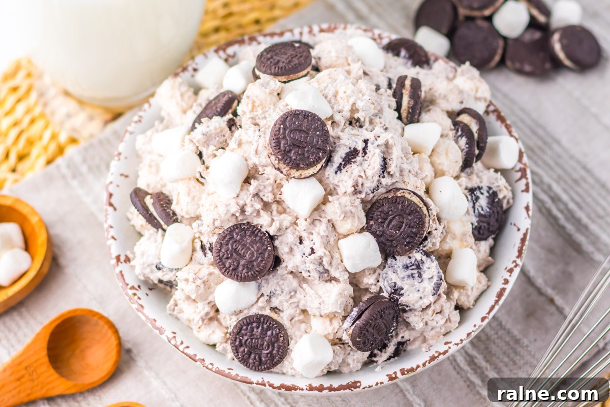 Creamy Oreo Fluff Dessert Recipe: No-Bake Oreo Delight 10 top down view of the fluff dessert garnished with marshmallows and mini oreo cookies.