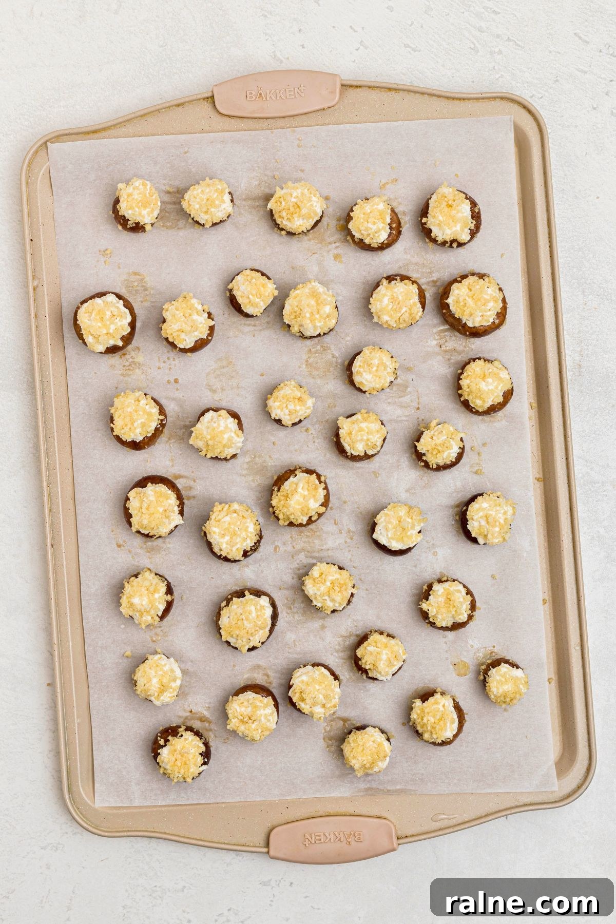 Cheesy Garlic Stuffed Mushrooms with Herb Breadcrumbs 8 Stuffed mushrooms on a baking sheet, lined with parchment paper.